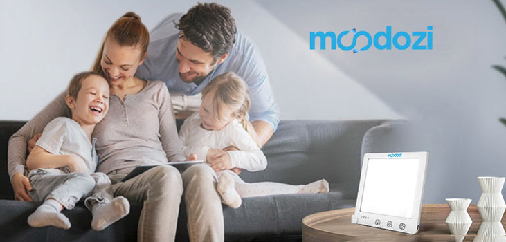family enjoying Moodozi SAD Lamp on the couch