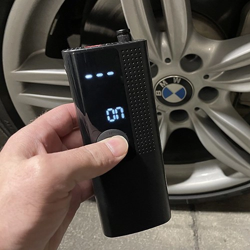 a man holding airmoto and turning it on.